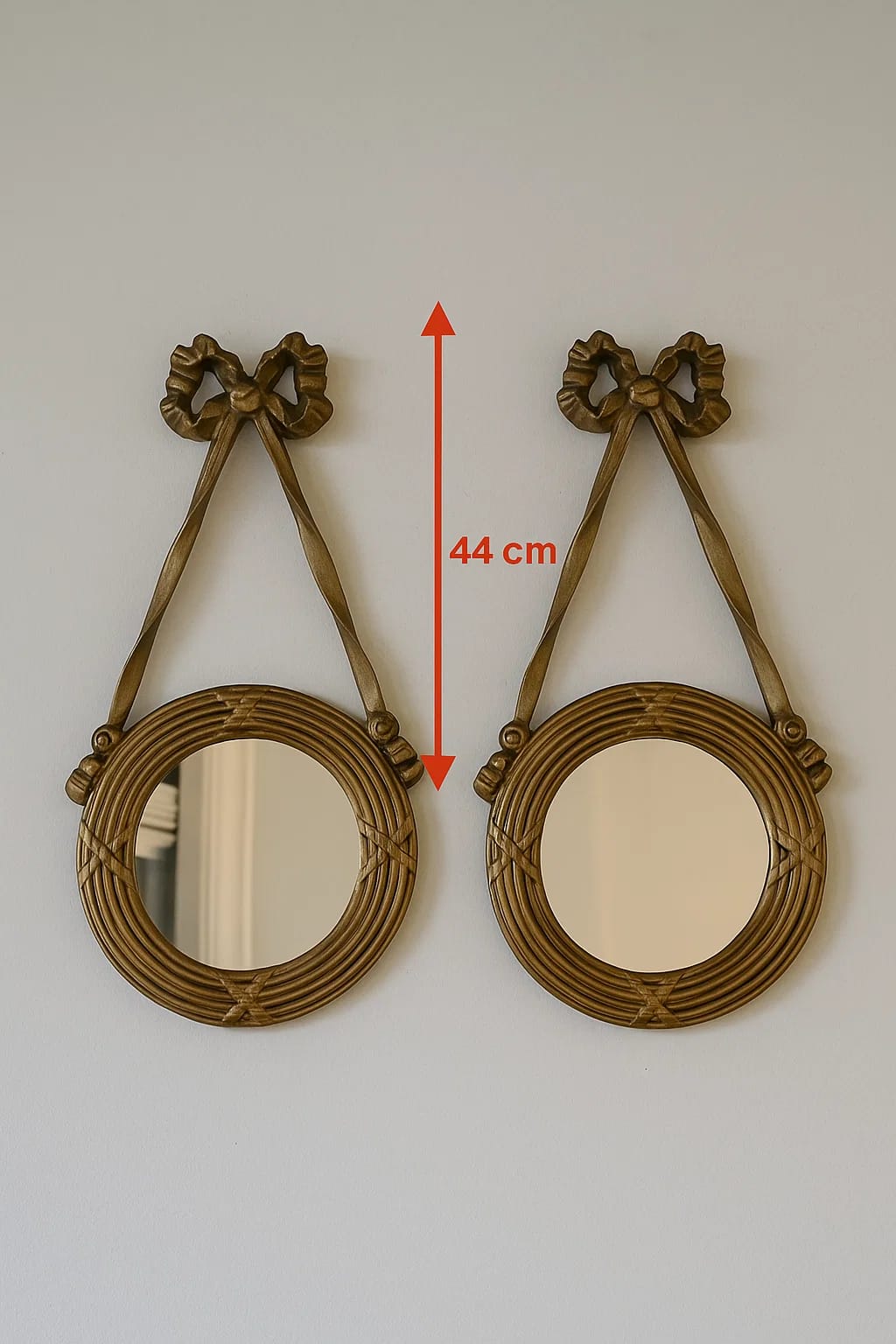 Charming round mirrors with a vintage-inspired ribbon-and-rope design. Cast in durable resin wit...