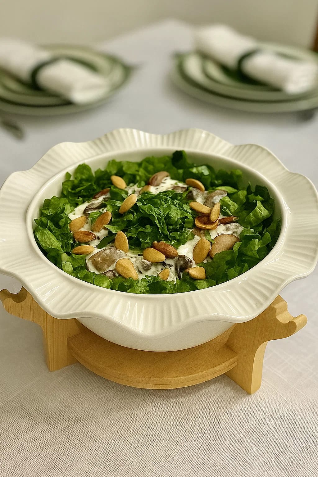A elegant scalloped-edge
ceramic bowl perched on a
natural wood riser.