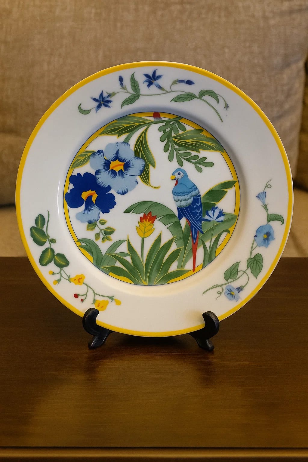 Hand-painted ceramic plate featuring a blue parrot among tropical flowers. Bright, collecti...